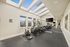 Bright and inviting fitness center with modern exercise equipment, skylight windows, and a sleek design.