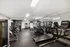 Modern gym with state-of-the-art treadmills, exercise equipment, and vibrant yoga balls, creating an inviting fitness space.