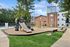 Charming apartment complex with an inviting children&rsquo;s playground and modern amenities nestled in a lush green setting.