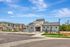 Charming suburban community featuring modern single-family homes, manicured landscaping, and spacious driveways under a clear blue sky.