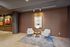 Chic lounge area featuring modern armchairs, a stylish side table, and elegant wall art, perfect for relaxation.