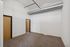 Modern room with high ceilings, exposed ductwork, and plush carpeting, showcasing spacious and stylish design.