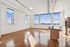Bright modern kitchen with sleek appliances and large windows offering stunning city views.
