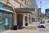 Vibrant city street view showcasing modern Rowe building exterior, blending historic charm with contemporary architecture.