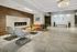 Luxurious lobby with a modern fireplace, elegant chandelier, and inviting seating in a contemporary apartment building.
