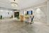 Elegant lobby with a striking chandelier, modern seating, and stylish wall art in a luxury residential building.