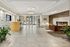 Elegant apartment lobby with modern fireplace, stylish seating, and chic chandelier creating a welcoming ambiance.