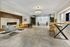 Elegant apartment lobby featuring a modern fireplace, luxurious seating, and stylish decor with a sleek chandelier.