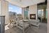 Inviting urban balcony with cozy seating, a modern fireplace, and breathtaking cityscape views.