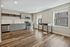 Bright modern kitchen with sleek stainless steel appliances, elegant cabinetry, and beautiful hardwood floors, offering a welcoming space for culinary creativity.
