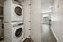 Contemporary apartment with a convenient in-unit stacked washer and dryer, modern flooring, and bright interior.