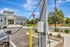 Charming residential clubhouse with an electric vehicle charging station in a serene, landscaped environment.