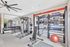 Modern fitness center featuring sleek equipment, weights, and open space for exercise, perfect for an active lifestyle.
