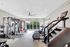Modern gym facility featuring state-of-the-art fitness equipment, including ellipticals, treadmills, and weight machines, with bright natural lighting and a spacious layout.