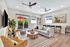 Inviting living room featuring a modern design with plush seating, vibrant decor, and a stylish outdoor patio view with red umbrella.