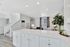 Bright modern open-plan kitchen and living area featuring sleek white cabinetry, elegant countertops, and stylish decor with natural light streaming in.