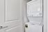 Compact laundry area with a modern stacked washer and dryer, optimizing space with stylish efficiency.
