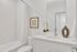 Elegant bathroom featuring a sleek white vanity, modern fixtures, and a bright, refreshing atmosphere.