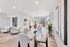 Modern open-concept living space featuring elegant dining area, cozy seating, and sleek kitchen with natural light.
