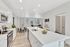 Bright and airy open-concept kitchen and dining area featuring modern white cabinetry, sleek countertops, and elegant wood flooring.