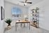 Bright and modern home office with stylish desk, lush greenery, and sleek shelving for an inspiring workspace.