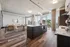 Sleek modern apartment interior featuring an open-plan kitchen and living area with panoramic city views.
