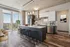 Sleek modern kitchen with a central island, stylish pendant lighting, and floor-to-ceiling windows offering stunning city views.