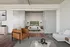Modern apartment with spacious living area featuring chic furniture and a cozy bedroom with sliding doors.
