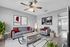 Modern living room with stylish gray sofas, vibrant red accents, and iconic wall art, featuring cozy lighting and lush greenery for a welcoming atmosphere.