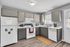 Modern kitchen with sleek gray cabinets, premium appliances, and natural light enhancing the inviting atmosphere.