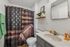 Chic bathroom with stylish football-themed shower curtain and elegant vanity design.