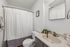 Elegant bathroom featuring a modern vanity, sleek mirror, and a chic shower curtain for a fresh and inviting feel.