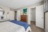 Modern bedroom with elegant decor, featuring a plush bed, chic dresser, and spacious walk-in closet for luxury living.