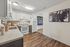 Modern kitchen with sleek white cabinetry, elegant countertops, and stylish lighting in a cozy apartment setting.