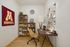 Cozy home office with stylish wooden desk, ergonomic chair, and vibrant decor for an inspiring workspace.