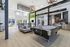 Modern apartment lounge with sleek pool table, cozy seating, and contemporary kitchen in bright, airy space.