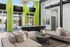 Modern lounge area with vibrant green walls featuring a sleek pool table, plush seating, and large windows revealing a poolside view.