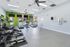 Bright, modern fitness center with state-of-the-art cardio equipment overlooking a serene outdoor pool.