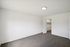 Bright, modern bedroom with plush carpeting and a walk-in closet, perfect for a cozy retreat.