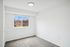 Bright and airy room featuring a large window with pleasant views, freshly painted walls, and plush carpeting.