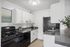 Modern kitchen with sleek black appliances, white cabinetry, and elegant decor for a sophisticated atmosphere.