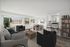Bright and airy living space featuring a modern open-concept design with cozy seating, stylish dining area, and expansive windows showcasing scenic views.