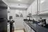 Chic kitchen with modern black appliances, elegant marble countertops, and ample white cabinetry, offering a bright, inviting space for culinary creativity.