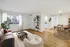 Bright and inviting living area featuring chic decor, warm wooden floors, and a cozy dining space, perfect for modern living.
