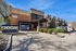 Contemporary apartment complex showcasing a stylish entrance with manicured landscaping at The Social at Stadium Walk Apartments.