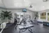 Bright and modern fitness center with state-of-the-art exercise machines, overlooking a serene outdoor view through large windows.