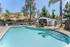 Inviting outdoor pool area surrounded by lush greenery and comfortable seating, perfect for relaxation and entertaining.