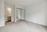 Bright bedroom with plush carpet and mirrored closet doors, leading to an elegant en-suite bathroom with modern fixtures.