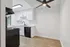 Contemporary kitchen with sleek cabinetry, modern appliances, and elegant wood flooring.