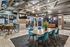Modern communal dining and lounge area featuring elegant lighting, contemporary furniture, and a stylish open design.